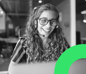Sales rep at work with headset speaking to a qualified lead over the phone via hotkey