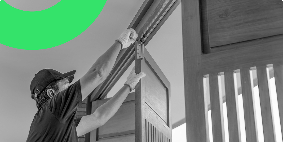 A male installation expert fitting bi-fold doors in a customer's home