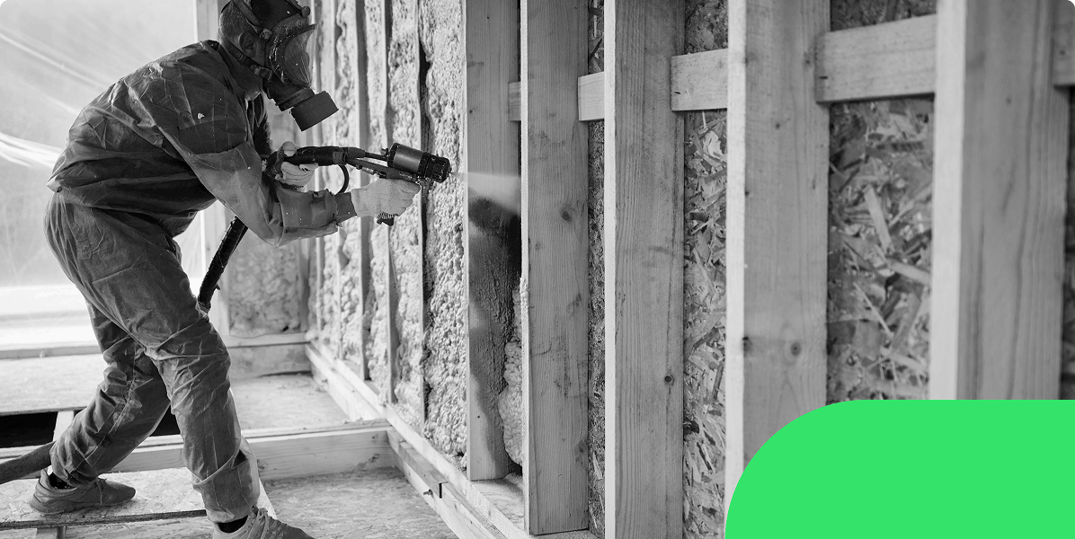 A spray foam removal technician using a foam dispensing gun to remove spray foam insulation from a loft wall