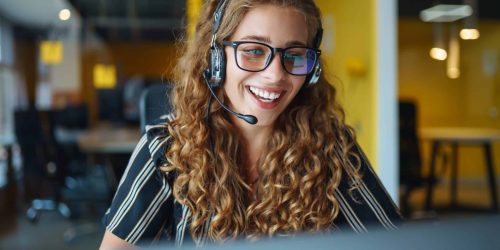 Smiling female sales rep talking to a home improvement customer via headset, quoting and closing a deal
